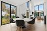 Dining space with a high ceiling, light wood finished floors, and recessed lighting