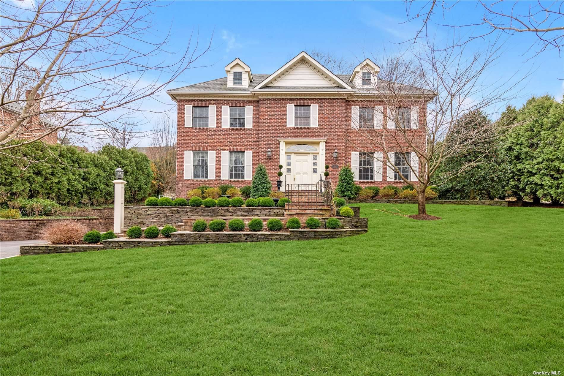 Magnificent Georgian Brick center hall colonial in the heart of Plandome Manor !