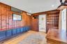 Office space featuring wooden walls, light wood finished floors, and recessed lighting