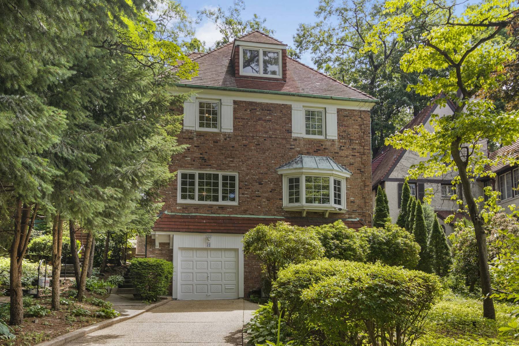Exquisite four story brick house located on a quiet tree lined block in the heart of Forest Hills Gardens.