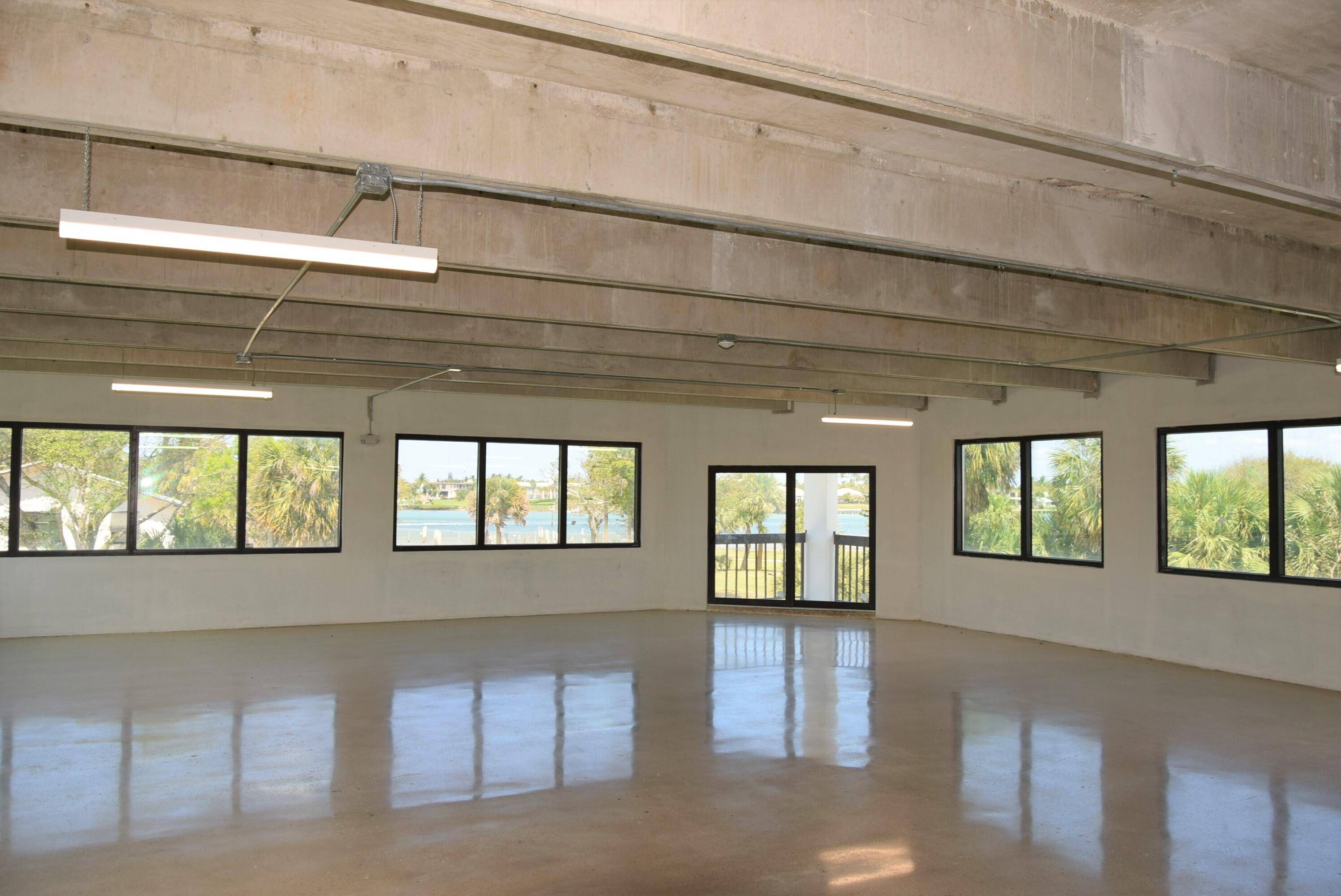 The second floor consists of 5, 232 SF of open office space with exposed 11' ceilings, polished concrete floors, and two bathrooms.