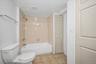 Bathroom with tile patterned floors and shower / bath combination
