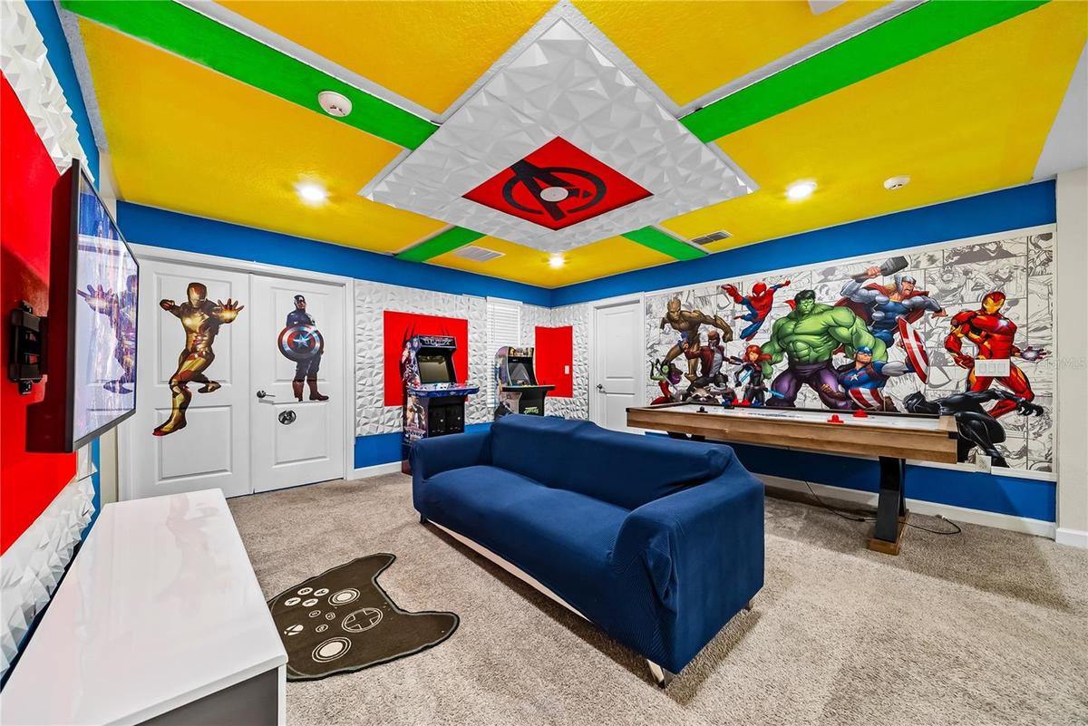 Avengers themed arcade game room with arcade games, pool table, smart TV