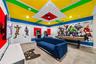 Avengers themed arcade game room with arcade games, pool table, smart TV