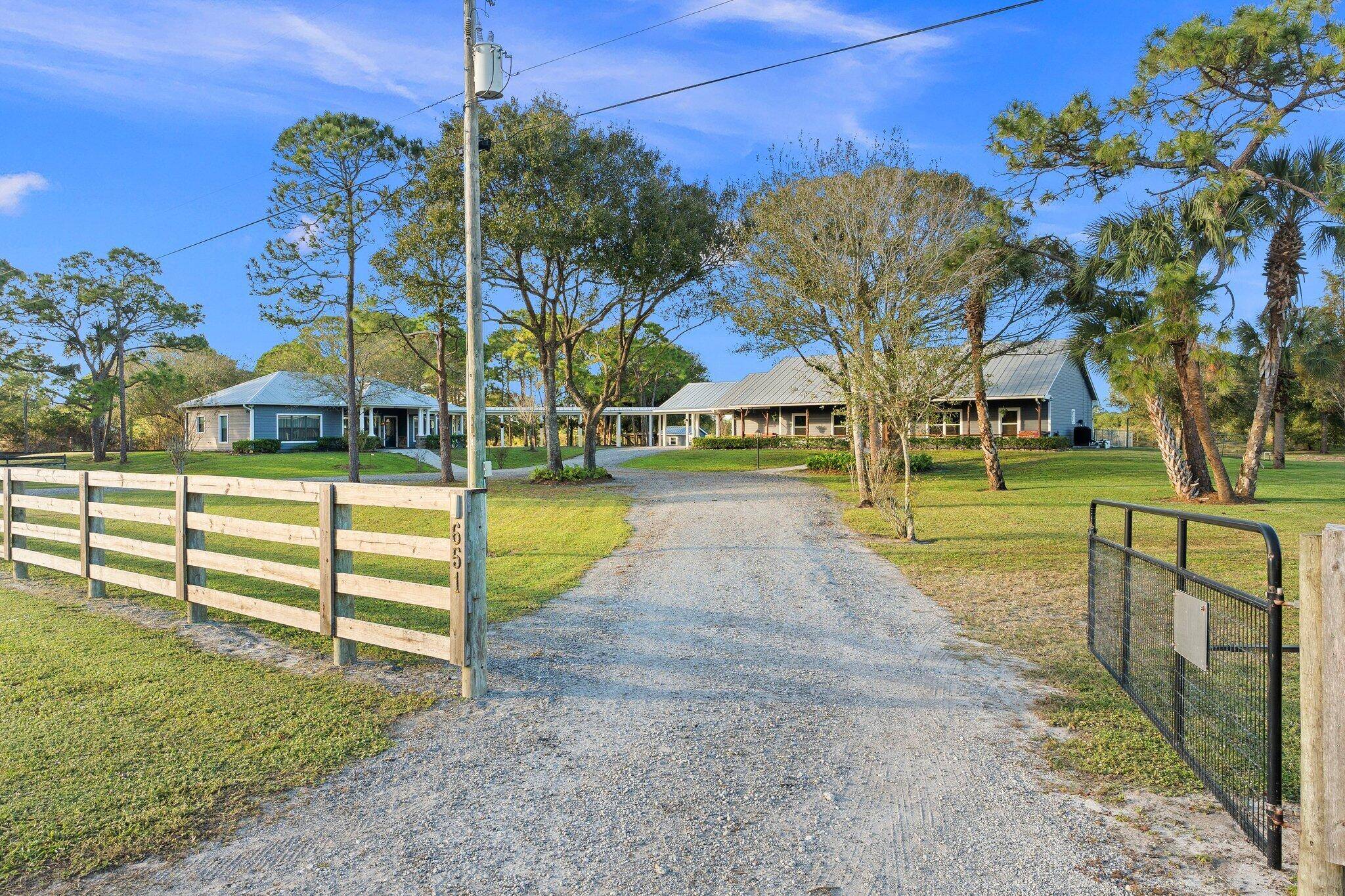 Beautifully maintained concrete block 3 2 pool home with separate custom 2 2 guest house, large barn, and additional detached storage.