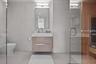 Bathroom featuring tile patterned floors, toilet, vanity, a shower with shower door, and tile walls