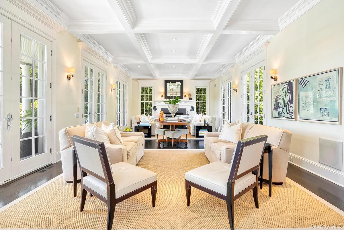 Sunroom featuring french doors, beam ceiling, and coffered ceiling