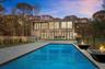Back of house at dusk featuring a patio area and a fire pit
