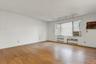 Unfurnished room featuring light wood-style flooring, track lighting, a textured ceiling, radiator, and cooling unit