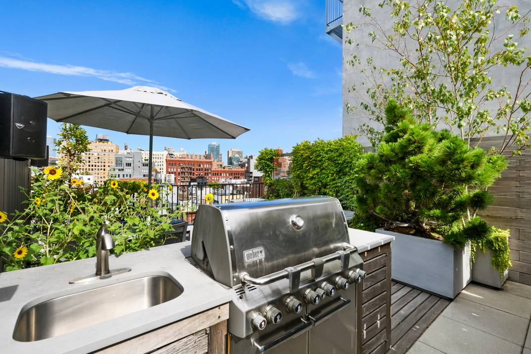Luxuries abound in this designer NoLita triplex with an expansive rooftop terrace with iconic views of the Empire State Building, Hudson Yards, 1 Vanderbilt, and One World Trade Center.