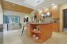 An oversized island anchors the space while skylights above bathe the kitchen in natural sunlight throughout the day.