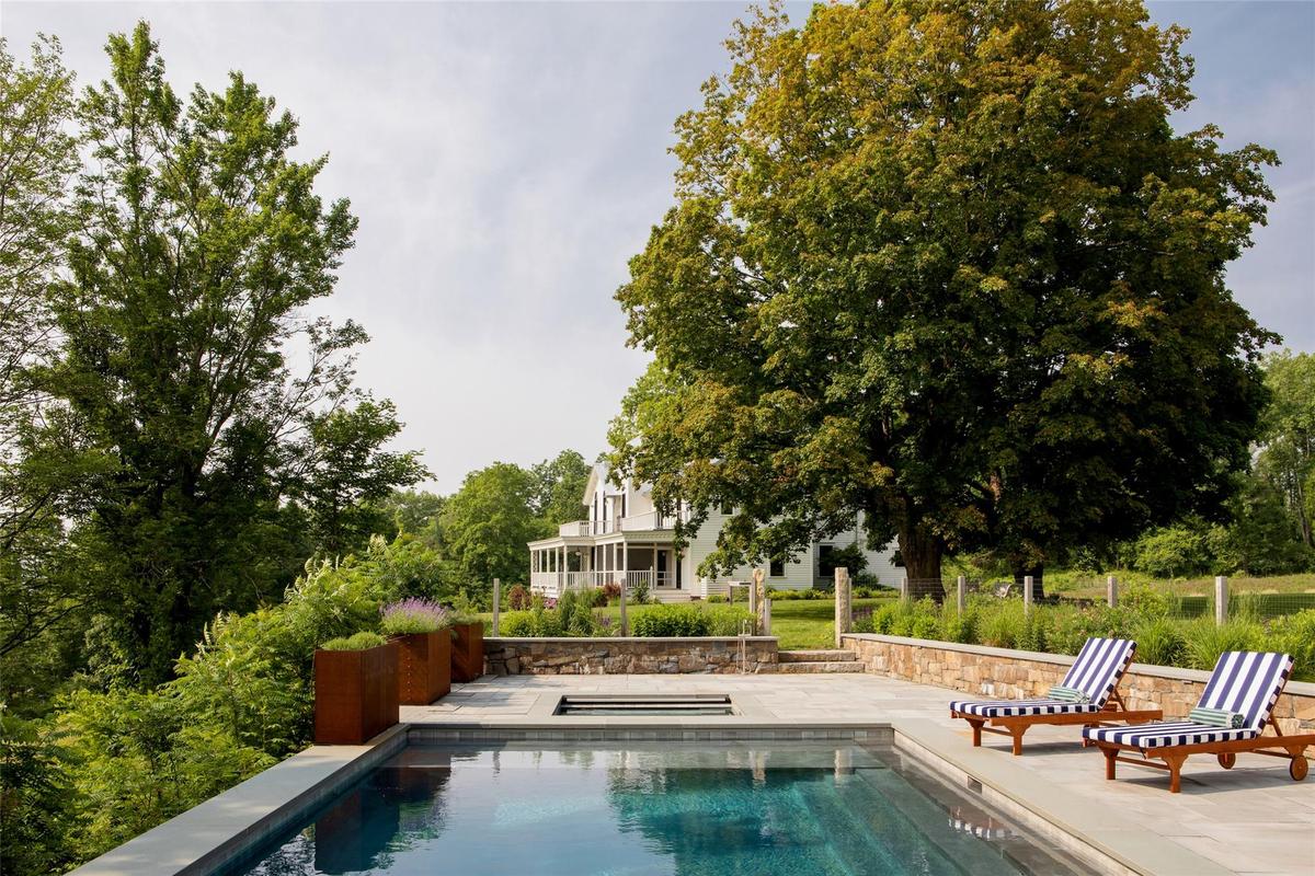 Swimming pool featuring an in-ground hot tub and a patio area