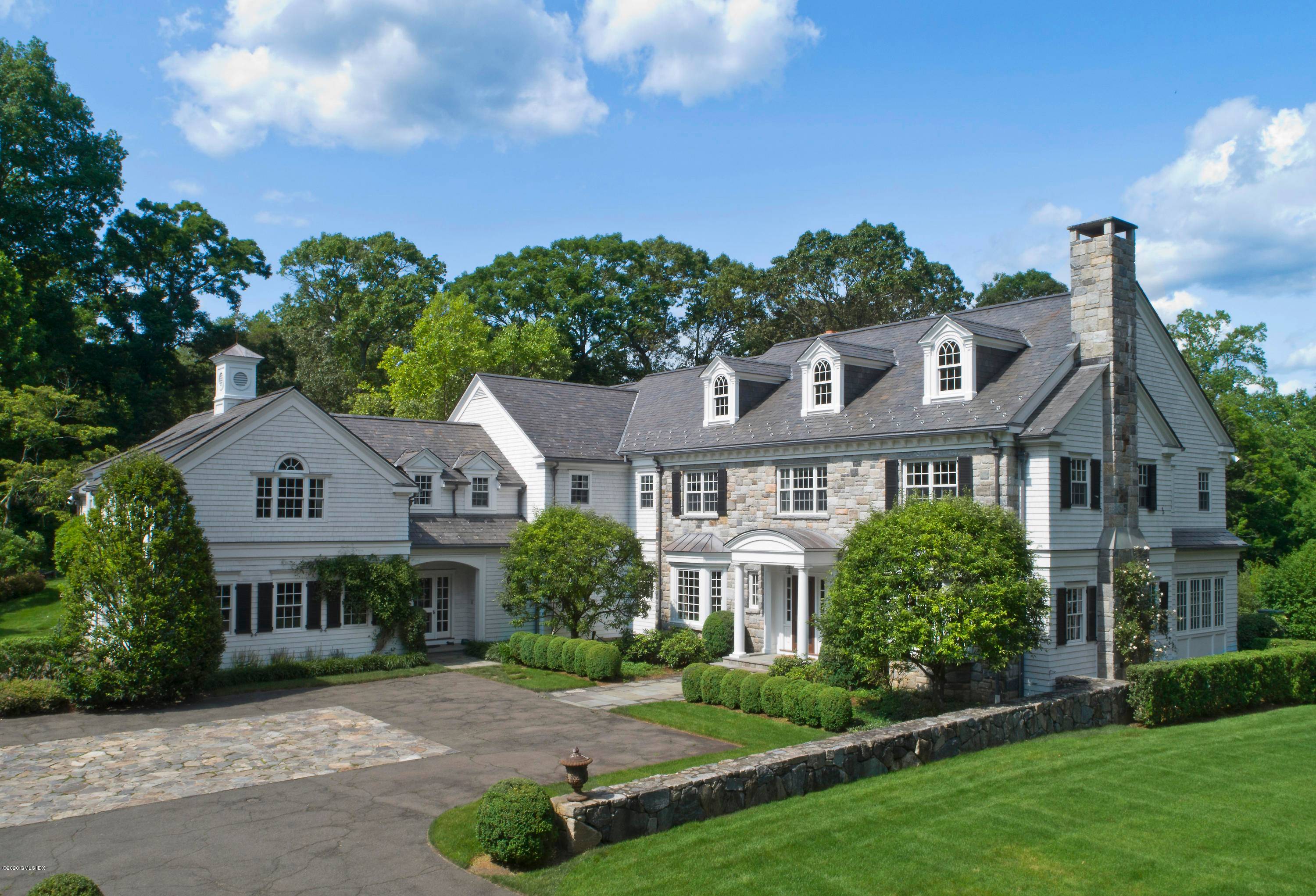 Located at end of private lane, classic stone clapboard Georgian, on nearly four acres in two acre zone.