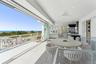 Wooden terrace featuring a ceiling fan, a water view, and outdoor dining area