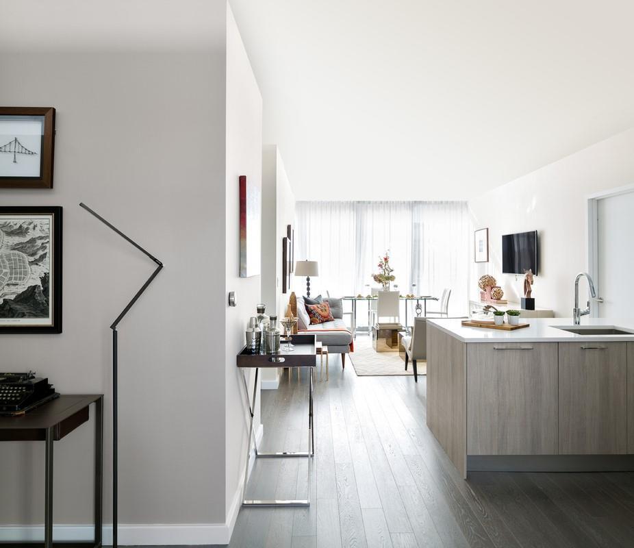 Kitchen with dark wood-type flooring, kitchen peninsula, and sink