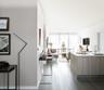 Kitchen with dark wood-type flooring, kitchen peninsula, and sink