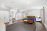 Spacious room featuring wood-finish flooring, recessed lighting, and multiple built-in storage units