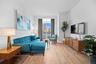 Living area featuring light wood-type flooring and ornamental molding