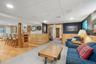 Living area featuring a paneled ceiling, wainscoting, wooden walls, recessed lighting, and carpet floors