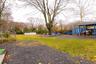 View of yard with a trampoline and an outbuilding