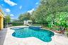 Stunning pool featuring a sunshelf with a umbrella holder and bubbler