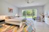 Bedroom with access to exterior, light wood-type flooring, and ceiling fan