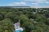 Aerial view featuring a forest view and a water view