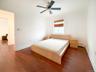 Bedroom with dark wood finished floors, a ceiling fan, and baseboard heating