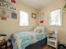 Bedroom featuring ornamental molding and wood finished floors
