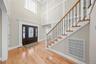 Foyer featuring light wood-style flooring, stairs, and crown molding