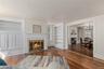 Wood burning fire place in the formal living room open to dining room with pocket doors