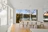 Dining room featuring a healthy amount of sunlight and a water view