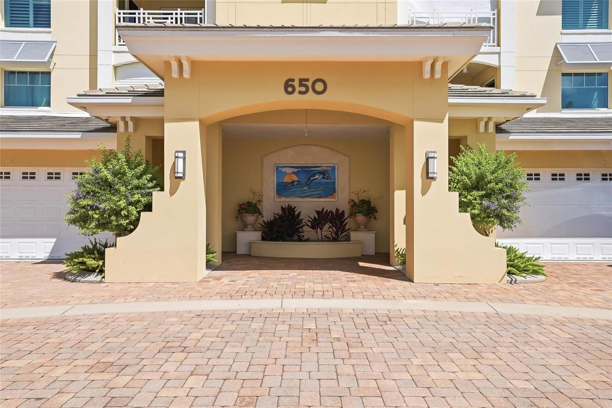 Private secured building entrance with elegant coastal architecture.