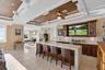 Club-style lounge with waterfall quartzite bar and elevated sunset views.