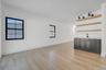 right dining space positioned beside kitchen and living room featuring wet bar and large glass sliders, offering great natural light and easy access t