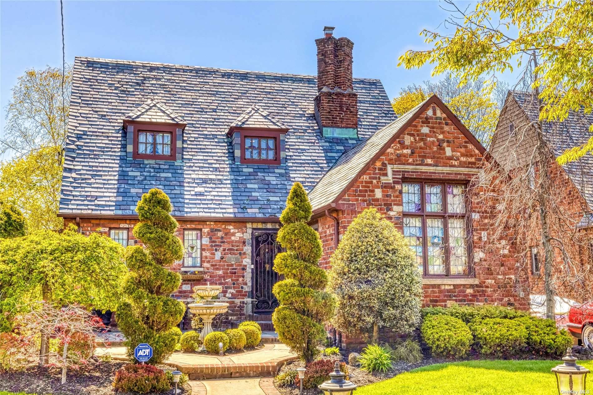 Beautiful and updated Brick Tudor with Slate Roof.