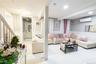 Living area with a decorative wall, a wainscoted wall, light tile patterned floors, a wall unit AC, and stairway