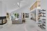 Spacious living area featuring a vaulted ceiling and recessed lighting