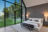 Second floor primary bedroom with stunning floor to ceiling windows and water views with en suite bath and expansive walk in closet