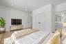 Private first floor junior primary bedroom with a full bath, ideal for guests, or a flexible office setup. Virtually Staged