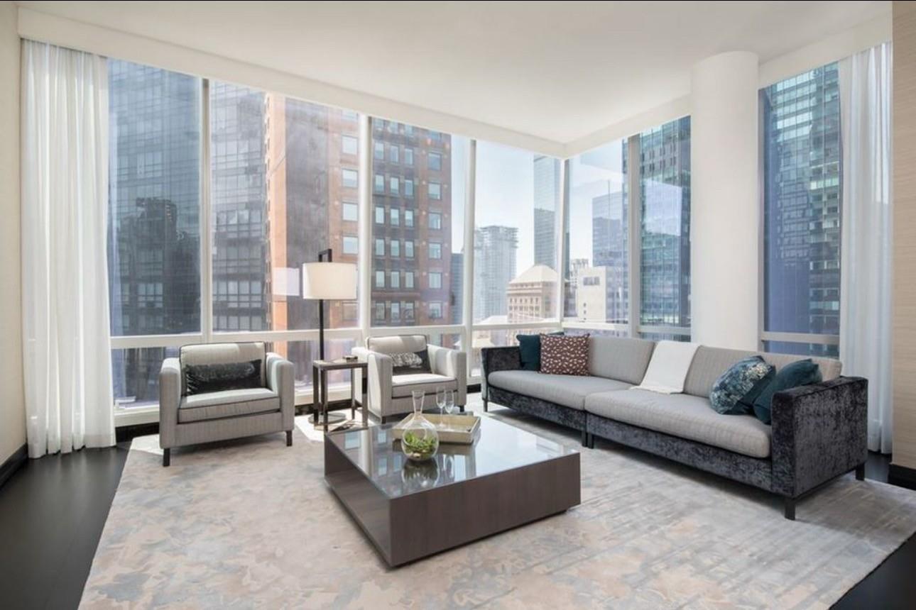 Living room with hardwood / wood-style flooring and expansive windows