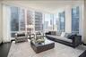 Living room with hardwood / wood-style flooring and expansive windows
