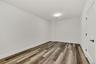Spare room featuring dark wood finished floors and baseboards