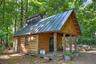 Traditional sugar shack nestled among the woodlands, supporting maple syrup production