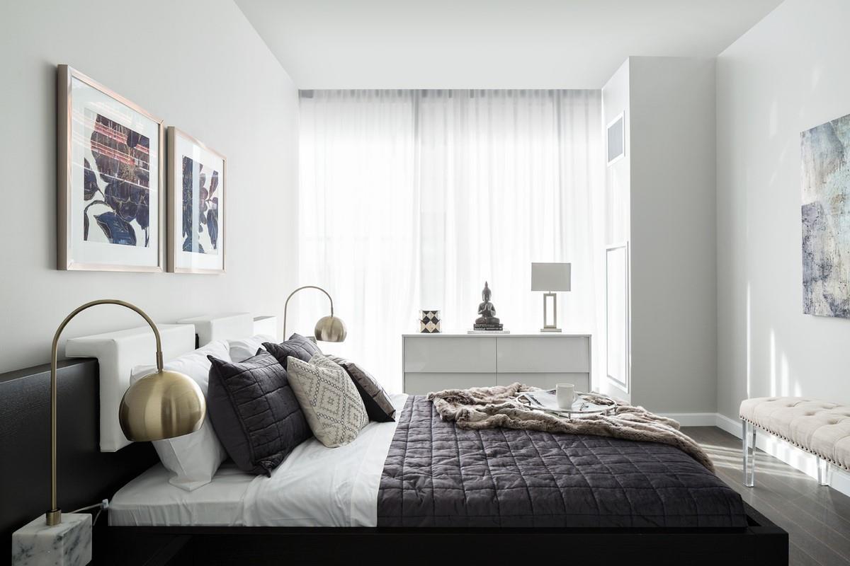 Bedroom with hardwood / wood-style floors and multiple windows