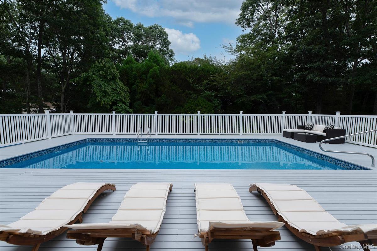 View of swimming pool with outdoor lounge area and a fenced in pool