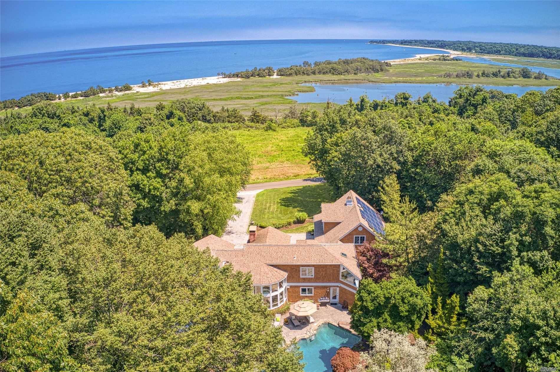 Luxurious, private, secluded, cedar shingled Hamptons style home with captivating water views, landscaped yard, and abundant natural light in every room !