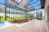 Covered lanai overlooks a private screened pool.