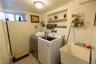 Laundry area featuring washer and clothes dryer, tile walls, and light tile patterned floors