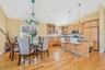 Dining space featuring lofted ceiling, light wood-style floors, and a chandelier